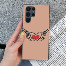 Load image into Gallery viewer, Ti Amo I love you - Exclusive Brand - Feldspar - Skeleton Hands with Heart - Samsung Galaxy S22 Ultra Glass Case
